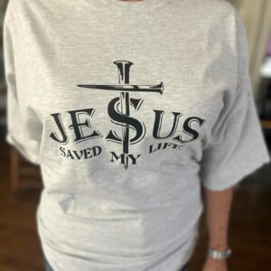 Light gray t-shirt with text: "Jesus Saved My Life" featuring a center cross out of nails. Available sizes: S-L Women's Cut